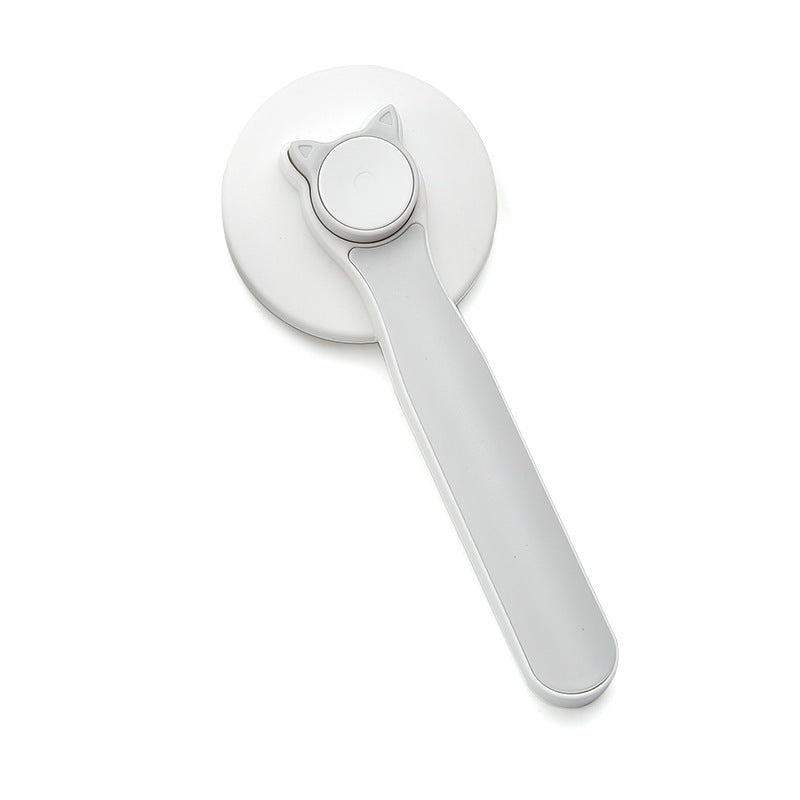 Self-cleaning grooming brush removing dog fur and tangles